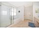 Bright bathroom featuring walk-in shower and bathtub, with large tiles, and double doors at 8217 Fan Palm Way, Kissimmee, FL 34747