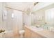Bright bathroom with shower-tub combo, toilet, and large mirror at 8217 Fan Palm Way, Kissimmee, FL 34747