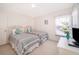 Bright bedroom with two twin beds, neutral decor, and a window with natural light at 8217 Fan Palm Way, Kissimmee, FL 34747