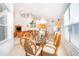 Bright dining space overlooking the kitchen and living area with wicker chairs and a glass table at 8217 Fan Palm Way, Kissimmee, FL 34747