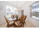 Cozy dining area featuring wicker furniture, a glass table, and plenty of natural light at 8217 Fan Palm Way, Kissimmee, FL 34747