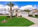 Charming two-story home featuring a well-manicured lawn, two car garage and inviting entryway at 8217 Fan Palm Way, Kissimmee, FL 34747
