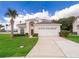 Charming home with a well-kept lawn, lush landscaping, and a two-car garage at 8217 Fan Palm Way, Kissimmee, FL 34747