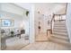 Inviting foyer features tile flooring, staircase, and views of the living room and kitchen at 8217 Fan Palm Way, Kissimmee, FL 34747