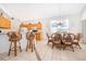 Kitchen and dining area with a breakfast bar, adjacent dining table, and ample counter space at 8217 Fan Palm Way, Kissimmee, FL 34747