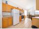 Bright kitchen featuring natural wood cabinets and white appliances at 8217 Fan Palm Way, Kissimmee, FL 34747