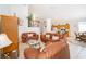 Open-concept living area with tile floors, high ceilings, wood accents and comfortable brown leather furniture at 8217 Fan Palm Way, Kissimmee, FL 34747