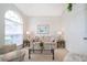 Cozy living room features a large arched window, neutral paint, and comfortable seating at 8217 Fan Palm Way, Kissimmee, FL 34747