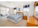 Bedroom with a sliding glass door to a screened lanai, side tables and a dresser at 8217 Fan Palm Way, Kissimmee, FL 34747