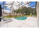 Relaxing screened-in pool area with lounge chairs, perfect for outdoor entertainment and leisure at 8217 Fan Palm Way, Kissimmee, FL 34747