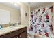 Bathroom featuring Mickey Mouse themed shower curtain, toilet seat, and decor at 9163 Wedge Dr, Davenport, FL 33896