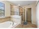 Bright bathroom with walk-in shower and soaking tub at 9163 Wedge Dr, Davenport, FL 33896