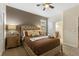 Bedroom showcasing a tufted headboard, soft lighting, and ensuite bathroom access at 9163 Wedge Dr, Davenport, FL 33896