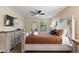 Spacious bedroom with TV, large window, and stylish decorative furniture at 9163 Wedge Dr, Davenport, FL 33896