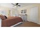 Bright bedroom featuring a large bed, dresser, and en-suite bathroom access at 9163 Wedge Dr, Davenport, FL 33896