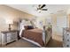 Well-lit bedroom with a decorative headboard, ceiling fan, and stylish furnishings at 9163 Wedge Dr, Davenport, FL 33896
