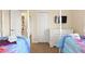 Bright bedroom featuring a Frozen theme, two twin beds, and an ensuite bathroom at 9163 Wedge Dr, Davenport, FL 33896
