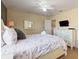 Bedroom with stylish bedding, ceiling fan, closet space and TV at 9163 Wedge Dr, Davenport, FL 33896