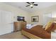 Cozy bedroom with neutral tones, ceiling fan, dresser, and plenty of natural light at 9163 Wedge Dr, Davenport, FL 33896