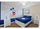 Charming bedroom features a playful Mickey Mouse wall design and comfortable furnishings at 9163 Wedge Dr, Davenport, FL 33896