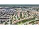 An expansive aerial view displays rows of homes within a well-designed community near commercial areas at 9163 Wedge Dr, Davenport, FL 33896
