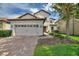 Charming two-story home with a well-manicured lawn and a two-car garage at 9163 Wedge Dr, Davenport, FL 33896