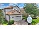 Charming two-story home with a well-manicured lawn and a two-car garage at 9163 Wedge Dr, Davenport, FL 33896
