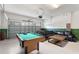 Finished garage featuring a pool table, foosball, and a sectional couch for entertaining at 9163 Wedge Dr, Davenport, FL 33896