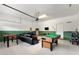Finished garage featuring a pool table, foosball, and a sectional couch for entertaining at 9163 Wedge Dr, Davenport, FL 33896