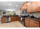 Beautiful kitchen featuring wood cabinets, stainless steel appliances and granite countertops at 9163 Wedge Dr, Davenport, FL 33896