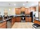 Well-equipped kitchen featuring wood cabinets, stainless steel appliances, and tile flooring at 9163 Wedge Dr, Davenport, FL 33896