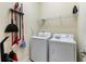 Functional laundry room with washer, dryer, and storage space for cleaning supplies at 9163 Wedge Dr, Davenport, FL 33896