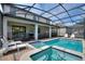 The backyard features a private screened-in pool with integrated spa and lounge chairs at 9163 Wedge Dr, Davenport, FL 33896