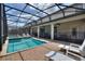 Spacious screened-in pool area with patio and outdoor dining space, ideal for entertaining at 9163 Wedge Dr, Davenport, FL 33896