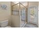 Shower featuring tile surround, glass enclosure, and door leading to backyard at 9163 Wedge Dr, Davenport, FL 33896