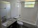 Bright bathroom featuring a tub and shower combination, tiled walls, and a granite vanity at 2721 N Poinciana Blvd # 163, Kissimmee, FL 34746