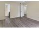 Neutral bedroom space with wood-style flooring and multiple doorways to other rooms at 2721 N Poinciana Blvd # 163, Kissimmee, FL 34746