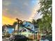 Charming two-story blue vacation home with arched windows and scenic sunset background at 2721 N Poinciana Blvd # 163, Kissimmee, FL 34746
