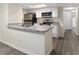Well-lit kitchen features modern stainless steel appliances and ample countertop space at 2721 N Poinciana Blvd # 163, Kissimmee, FL 34746