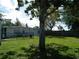 Spacious backyard featuring lush green grass and mature trees at 1004 Catherine St, Kissimmee, FL 34741