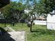 Backyard featuring a stone patio, lawn, and a storage shed at 1004 Catherine St, Kissimmee, FL 34741