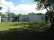 View of the backyard with a well-maintained lawn and exterior of the house at 1004 Catherine St, Kissimmee, FL 34741