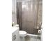 Full bathroom with neutral-toned shower curtain, toilet, and vanity for storage at 1004 Catherine St, Kissimmee, FL 34741