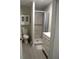 A modern bathroom with walk-in shower, tiled walls, vanity and toilet at 1004 Catherine St, Kissimmee, FL 34741