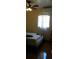 Bright bedroom with clean lines, featuring a window with curtain, and tiled flooring at 1004 Catherine St, Kissimmee, FL 34741