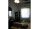 A simple bedroom with a window and view, featuring neutral-colored bedding and a cabinet at 1004 Catherine St, Kissimmee, FL 34741