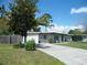 Well-maintained home with a simple front yard and a long driveway, offering convenience and curb appeal at 1004 Catherine St, Kissimmee, FL 34741