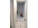 Hallway with tile floors and neutral walls, offering access to multiple rooms at 1004 Catherine St, Kissimmee, FL 34741