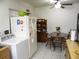 Cozy kitchen featuring white appliances, tile flooring, and a breakfast table set at 1004 Catherine St, Kissimmee, FL 34741