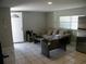 Inviting living room features tile floors, neutral color and a view of the entry door at 1004 Catherine St, Kissimmee, FL 34741